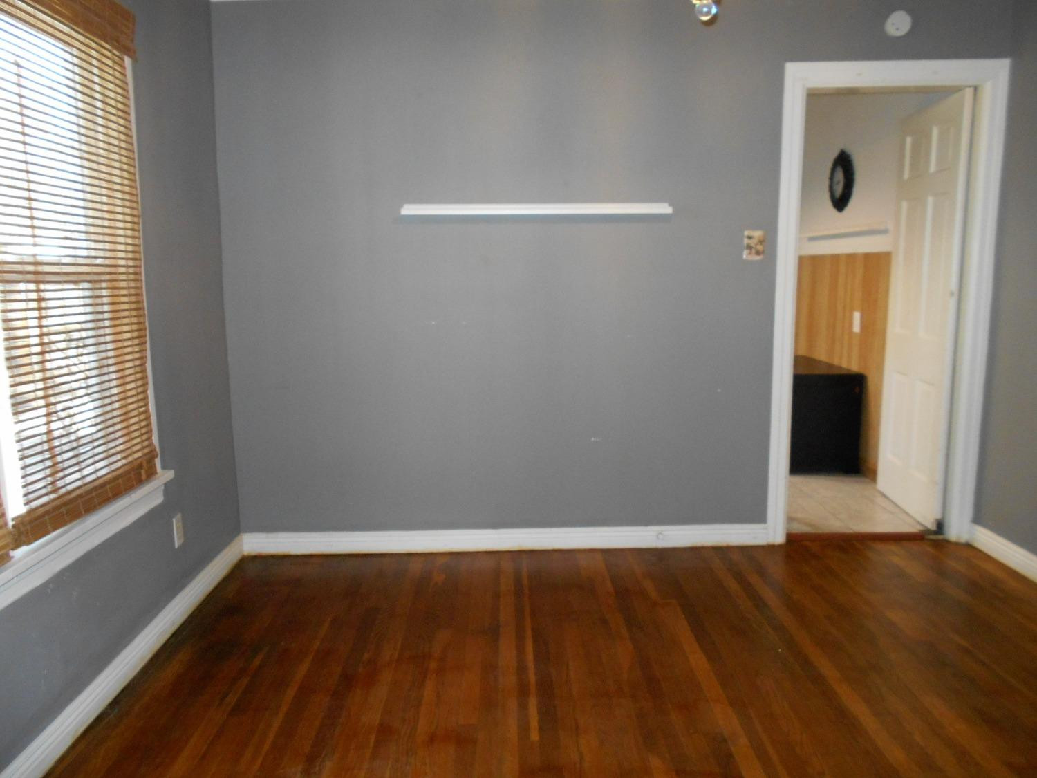 2518 25th Street Lubbock, TX 79410 - Photo 5 of 39 a view of a room with wooden floor and a window