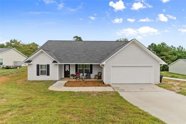 a front view of house with yard outdoor seating and barbeque oven
