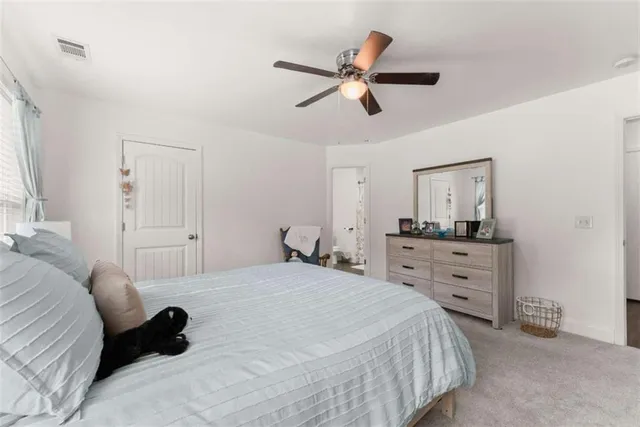 a bedroom with a bed and a dresser