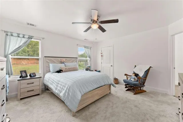 a bedroom with a bed a chair and bed