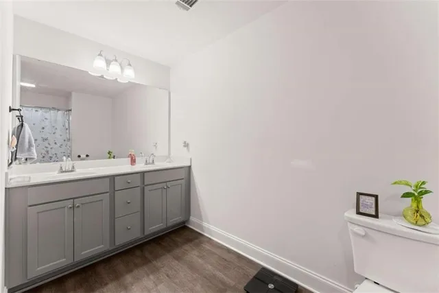 a bathroom with a double vanity sink and a mirror