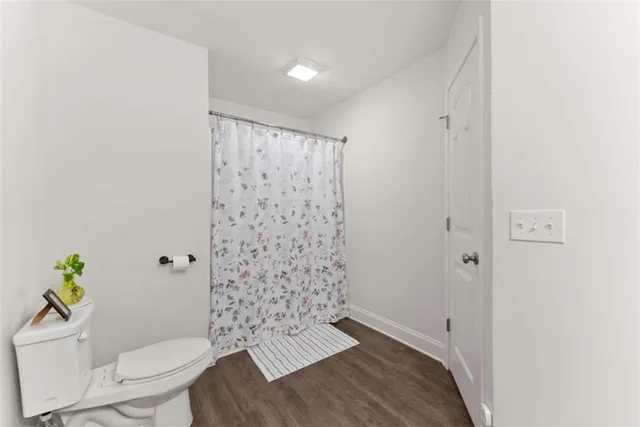 a bathroom with a toilet and a shower