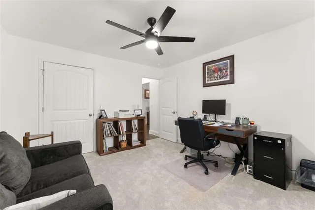 a livingroom with workspace and a couch