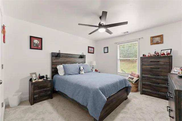 a bedroom with a bed and a ceiling fan