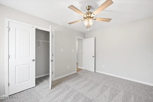 an empty room with a fan and a fan