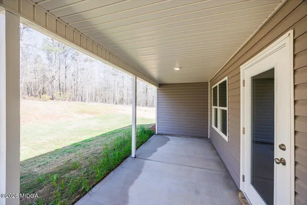 a view of a porch with wooden floor and stairs