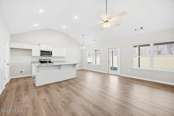 a view of kitchen with sink and wooden floor