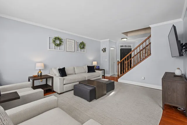 a living room with furniture and a stairs