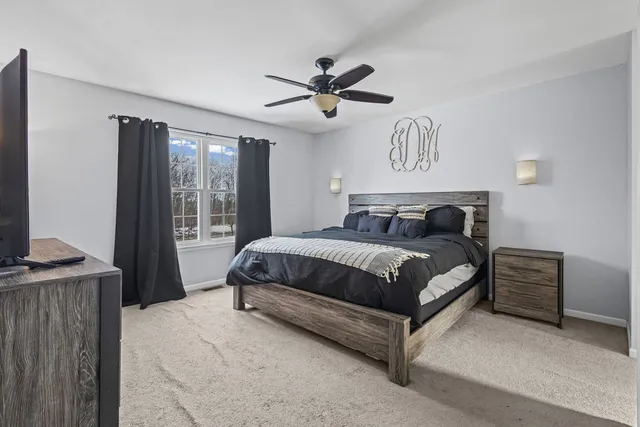 a bedroom with a bed and window