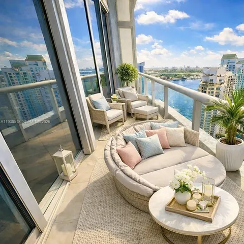 a view of a balcony with furniture and a floor to ceiling window