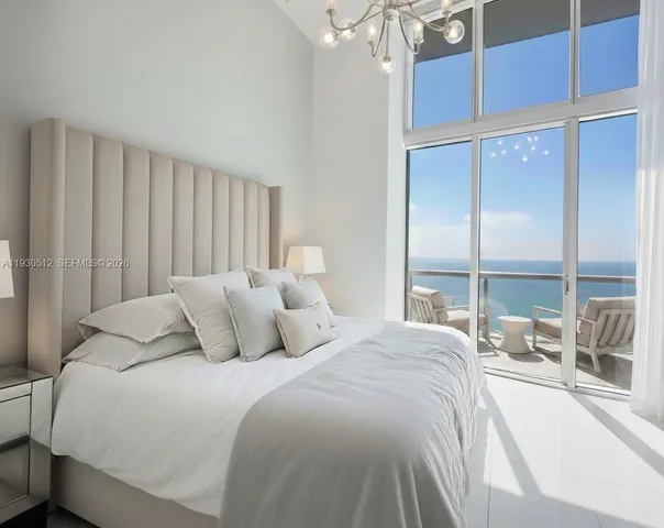 a bedroom with a large bed and a large window