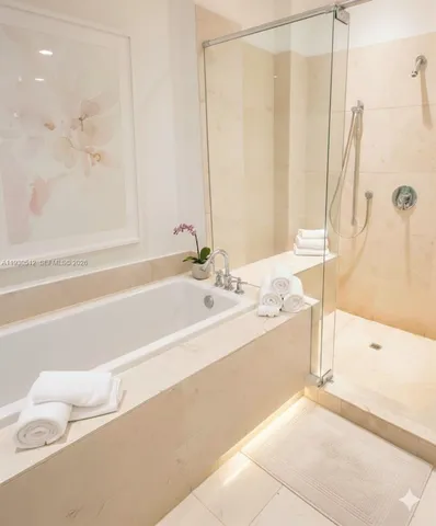 a spacious bathroom with a bathtub and shower