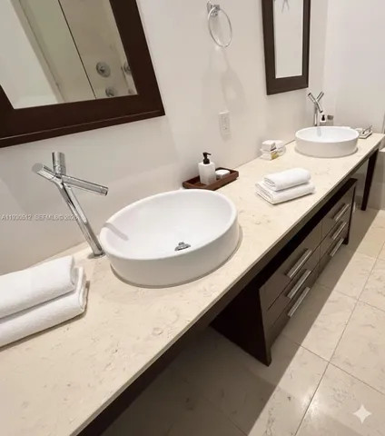 a bathroom with a double vanity sink and a mirror