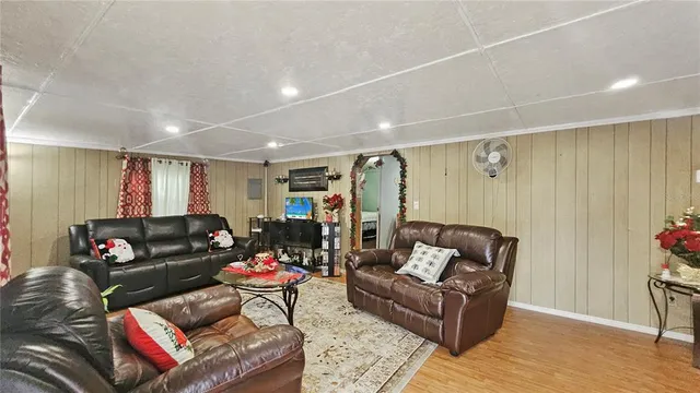 a bedroom with a bed a mirror on dresser and a chandelier
