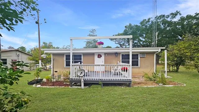 a view of a house with a yard deck and a chair
