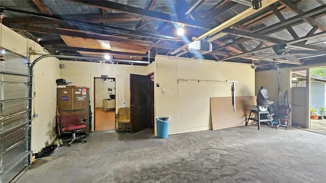 a view of a workspace with furniture and a ceiling fan