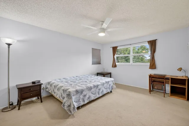 a bedroom with a bed and a desk