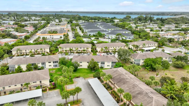 an aerial view of residential houses with outdoor space and swimming pool