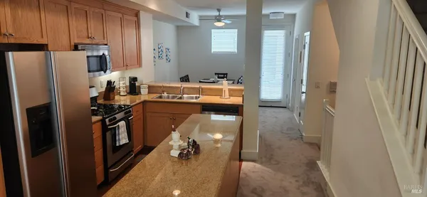 a kitchen with refrigerator and window