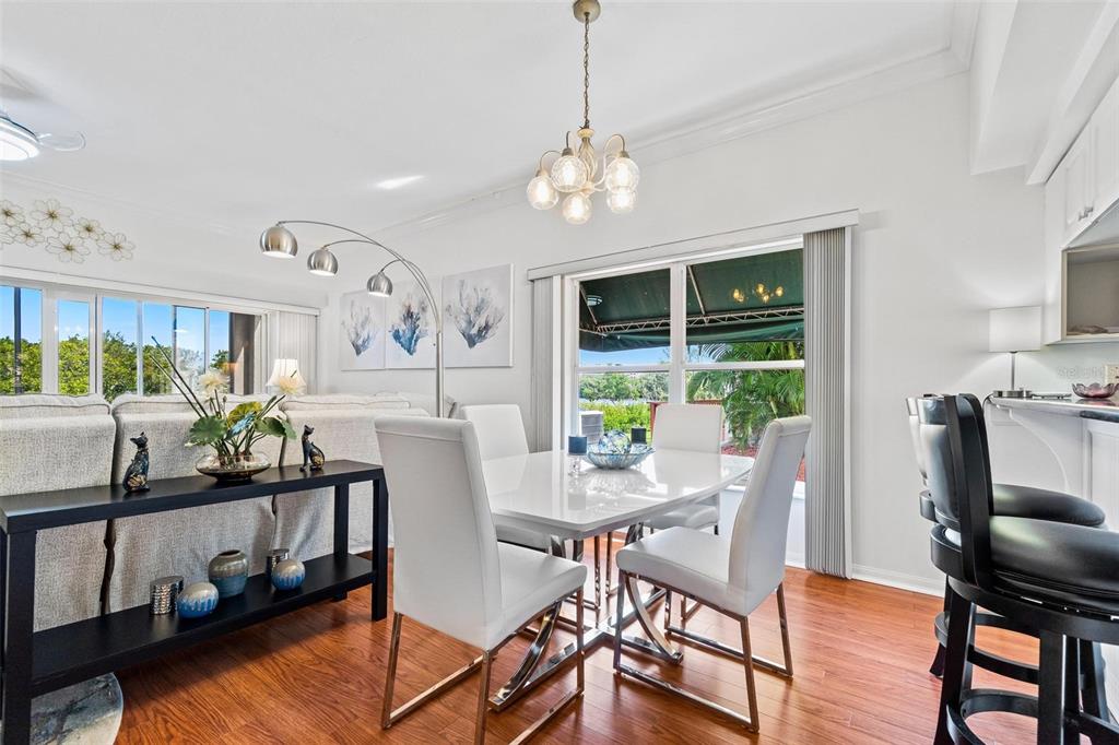 6555 99th Way North, Unit 20F St. Petersburg, FL 33708 - Photo 11 of 36 a view of a dining room with furniture window and outside view