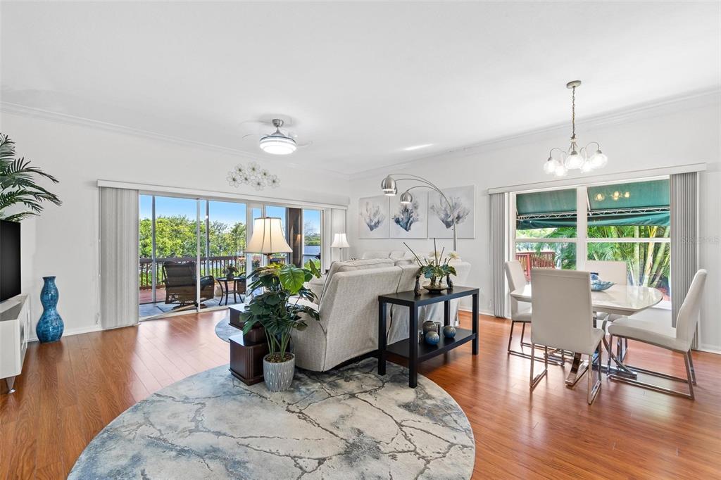 6555 99th Way North, Unit 20F St. Petersburg, FL 33708 - Photo 14 of 36 a living room with furniture potted plant and a large window