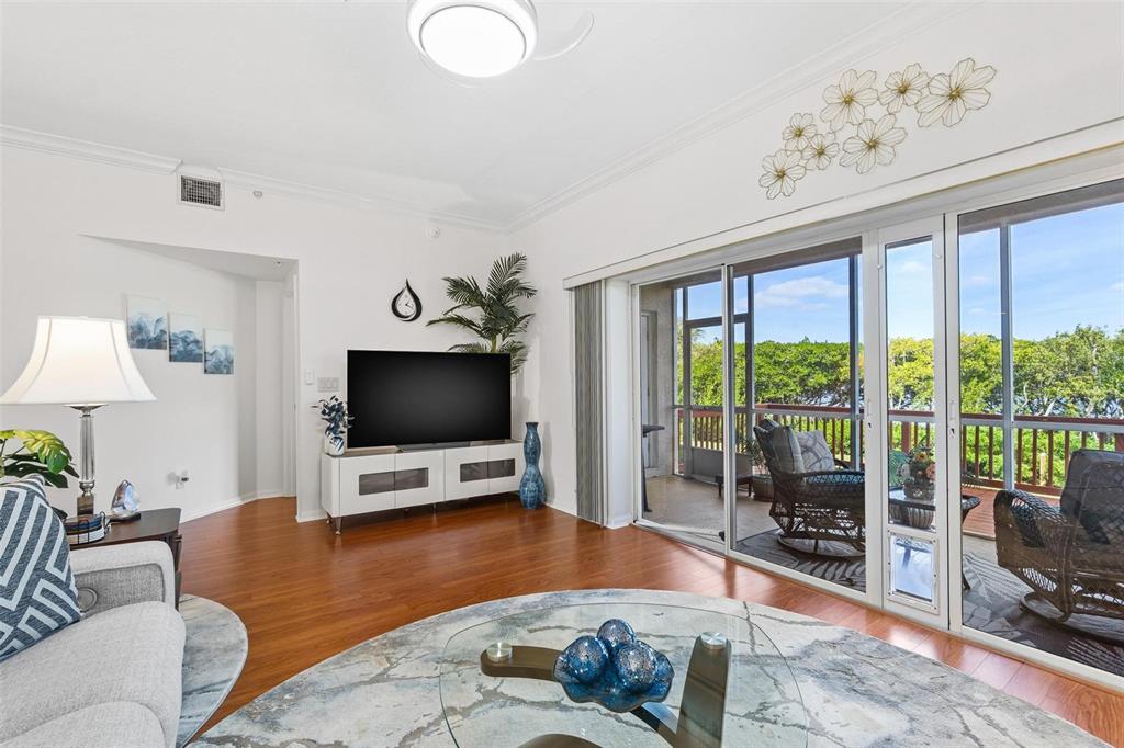6555 99th Way North, Unit 20F St. Petersburg, FL 33708 - Photo 15 of 36 a living room with furniture and a flat screen tv