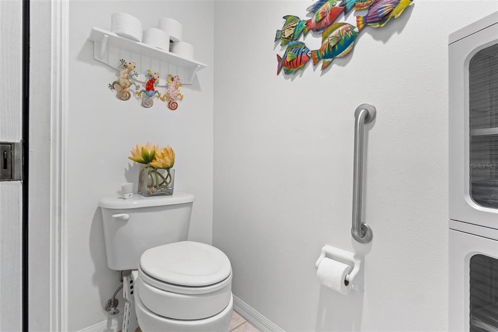 6555 99th Way North, Unit 20F St. Petersburg, FL 33708 - Photo 24 of 36 a white toilet sitting next to a bathroom sink