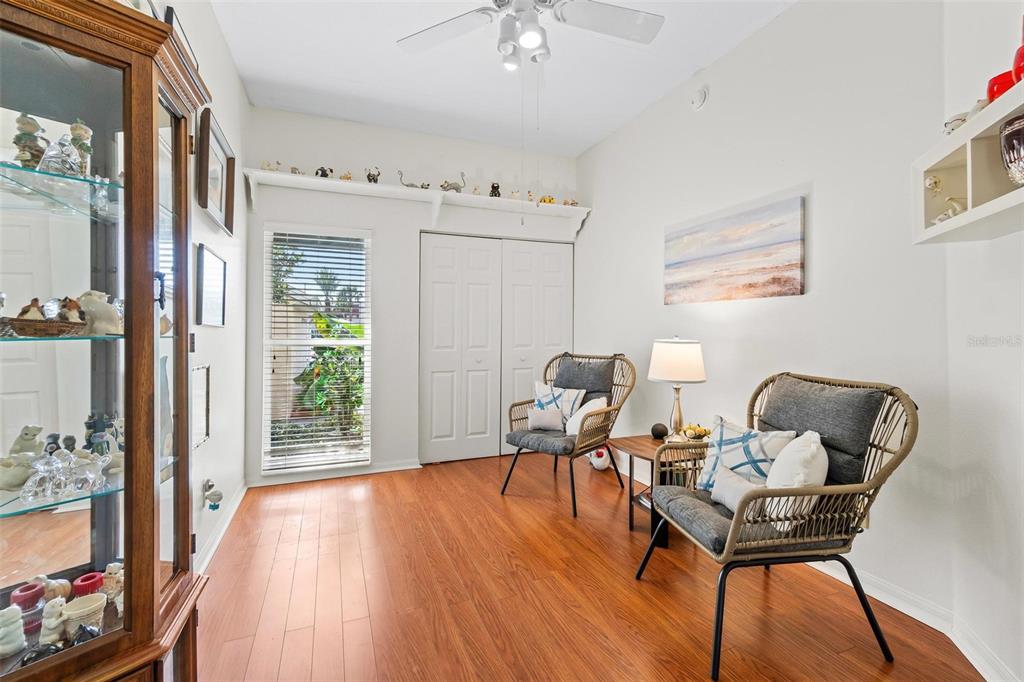 6555 99th Way North, Unit 20F St. Petersburg, FL 33708 - Photo 28 of 36 a work room with furniture and wooden floor