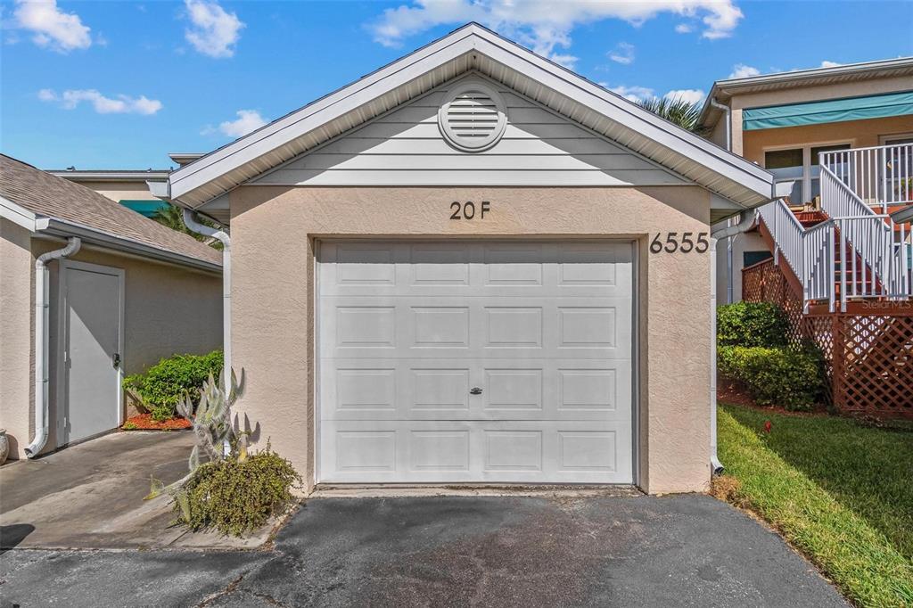 6555 99th Way North, Unit 20F St. Petersburg, FL 33708 - Photo 5 of 36 a front view of a house with a yard