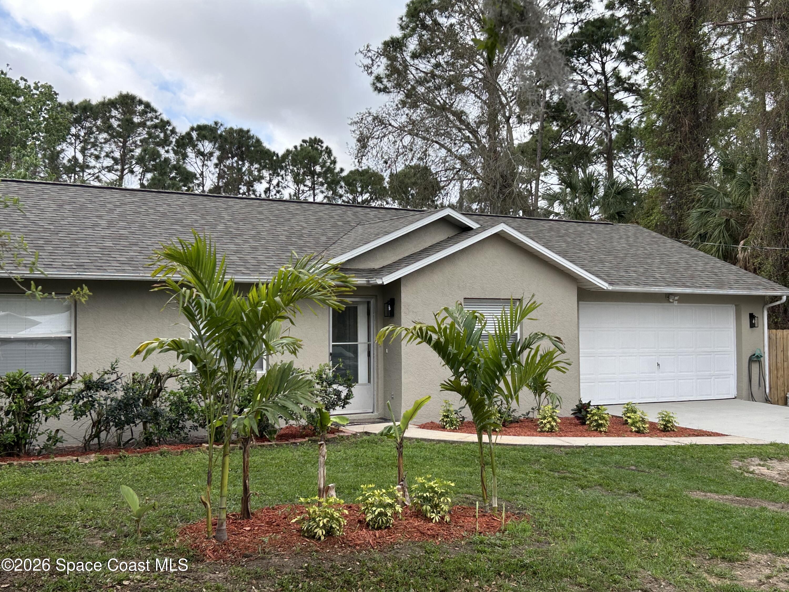 3785 Bird Street Cocoa, FL 32927 - Photo 1 of 15 a view of a house with a yard and plants