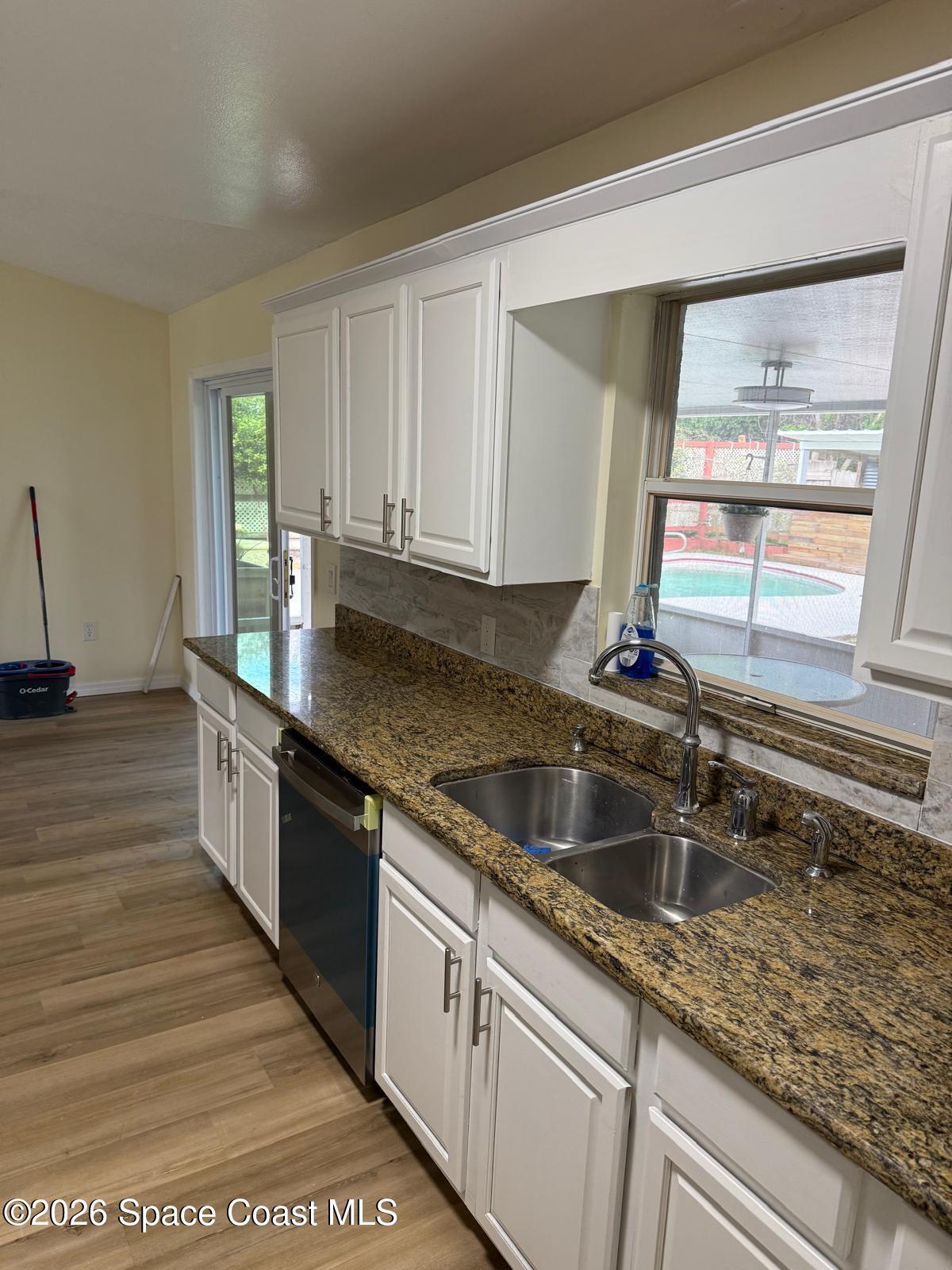 3785 Bird Street Cocoa, FL 32927 - Photo 11 of 15 a kitchen with granite countertop a sink and a stove