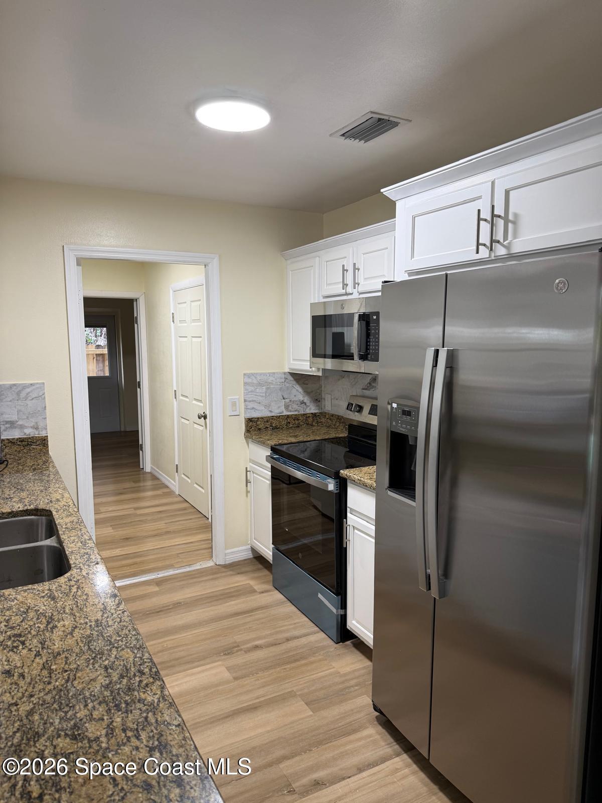 3785 Bird Street Cocoa, FL 32927 - Photo 12 of 15 a kitchen with a refrigerator sink and stove