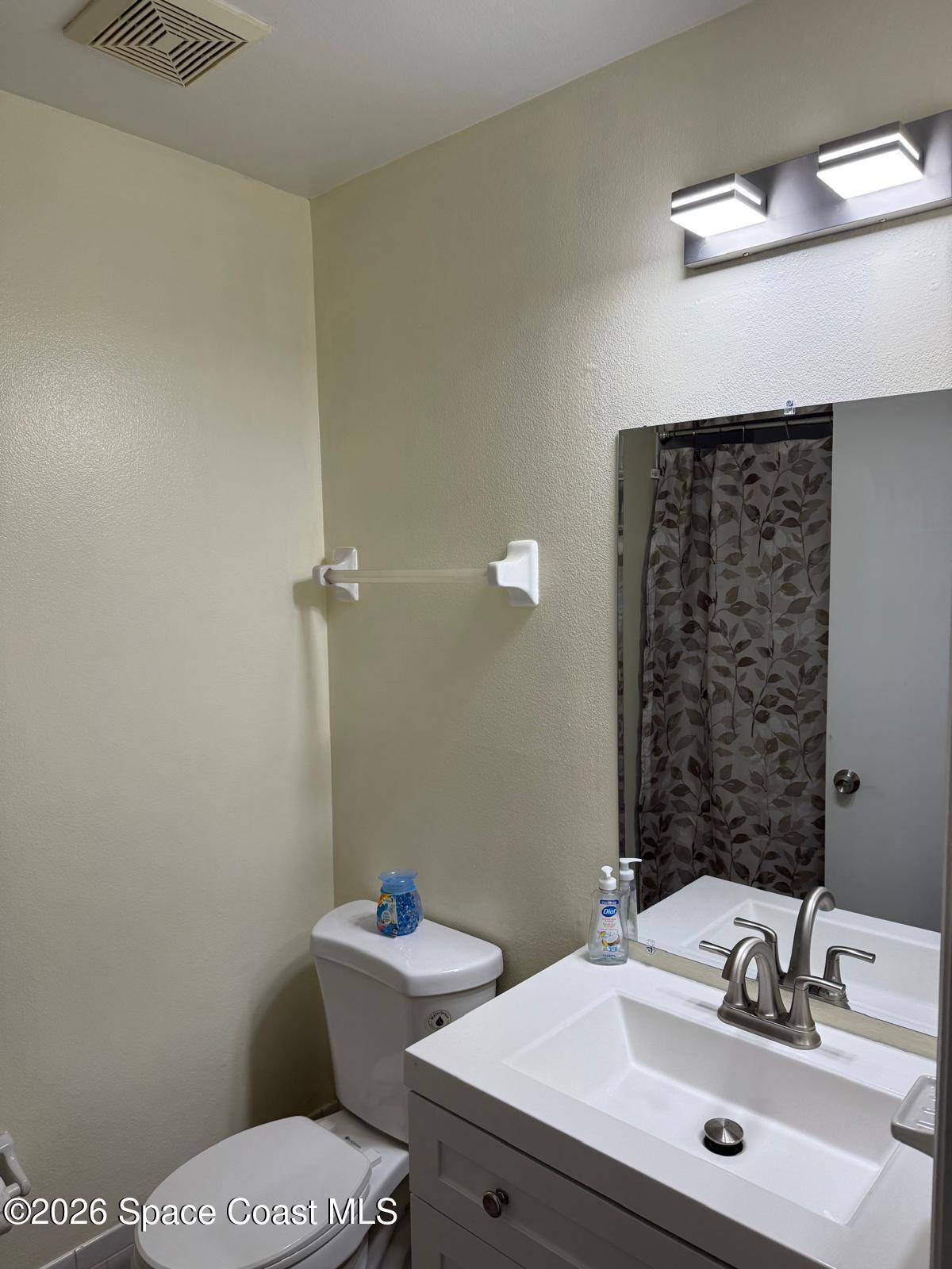 3785 Bird Street Cocoa, FL 32927 - Photo 15 of 15 a bathroom with a sink mirror and toilet