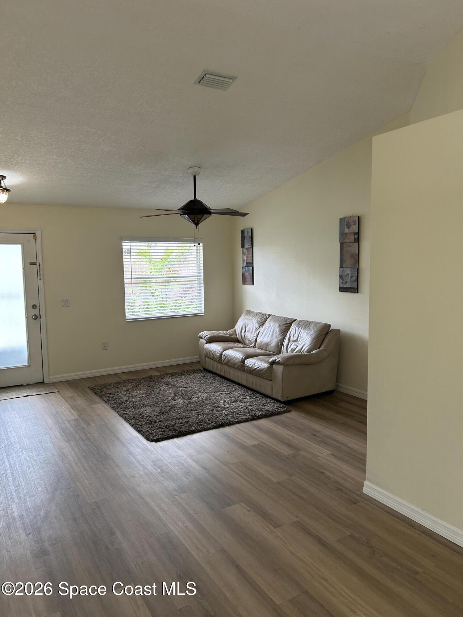 3785 Bird Street Cocoa, FL 32927 - Photo 2 of 15 a bedroom with a bed and wooden floor