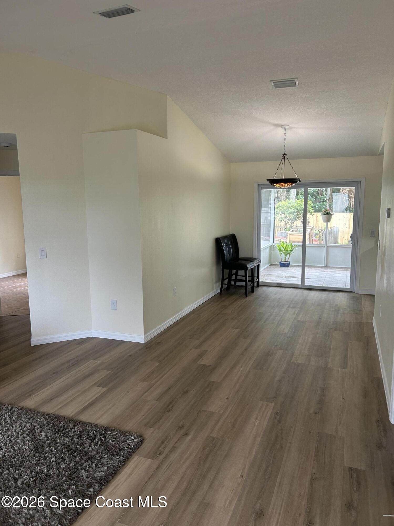 3785 Bird Street Cocoa, FL 32927 - Photo 4 of 15 an empty room with wooden floor and furniture