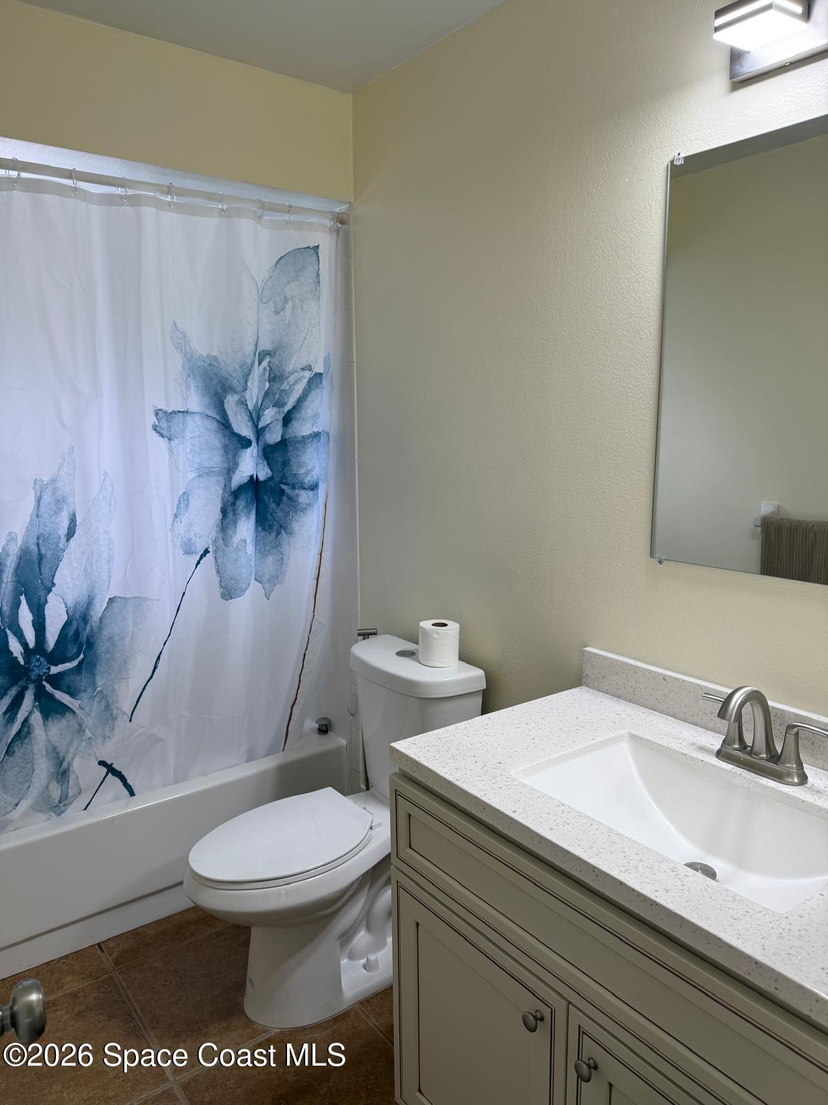 3785 Bird Street Cocoa, FL 32927 - Photo 8 of 15 a white toilet sitting next to a bathroom sink