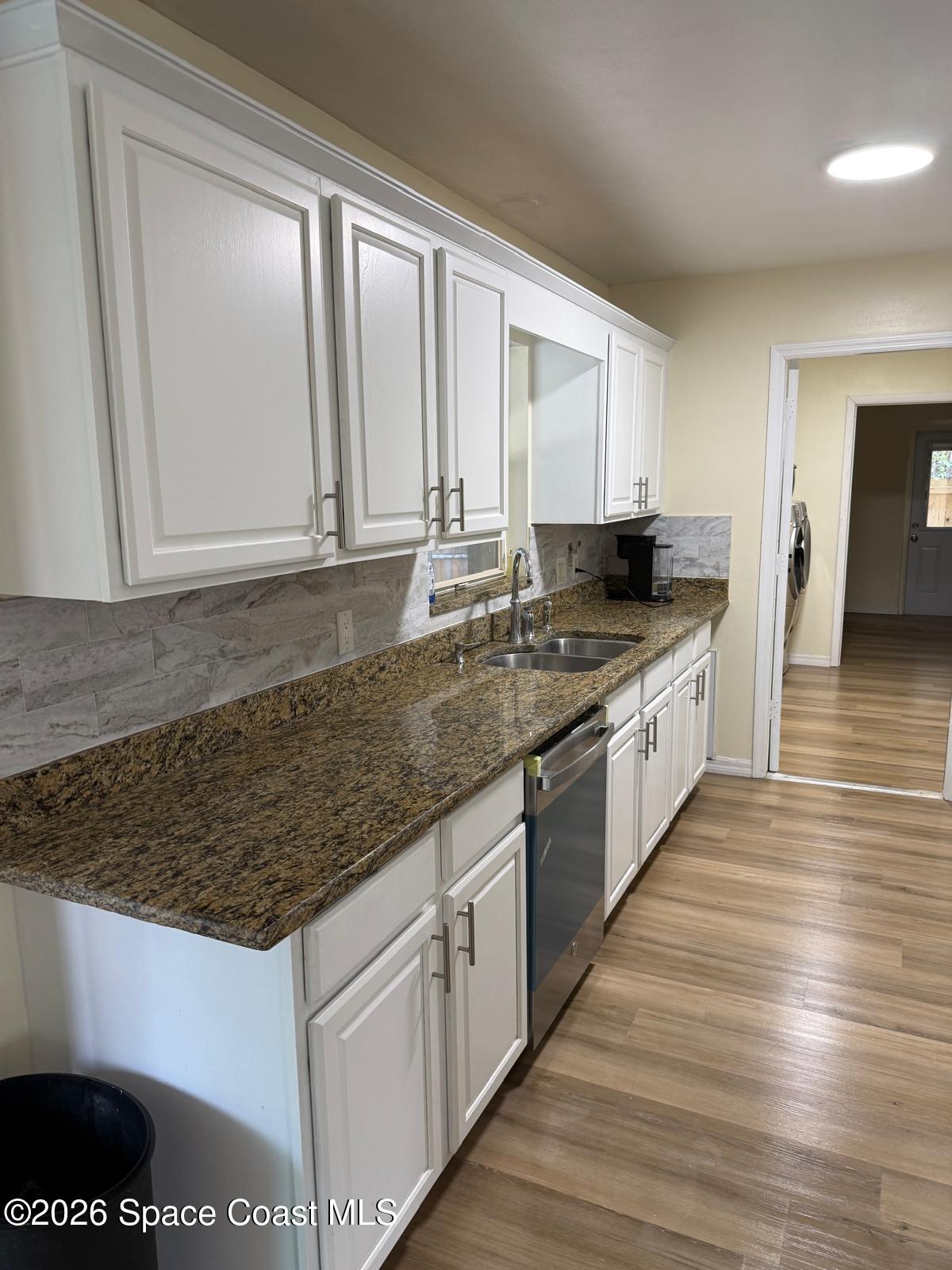 3785 Bird Street Cocoa, FL 32927 - Photo 10 of 15 a kitchen with stainless steel appliances granite countertop a sink stove and cabinets