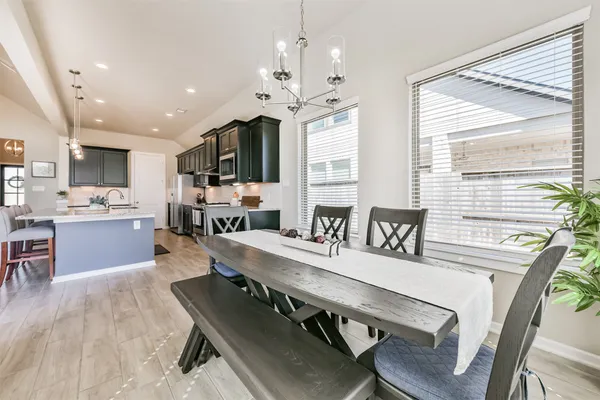 a large kitchen with a table and chairs