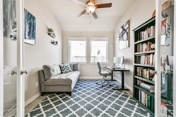 a living room with lots of furniture and a book shelf