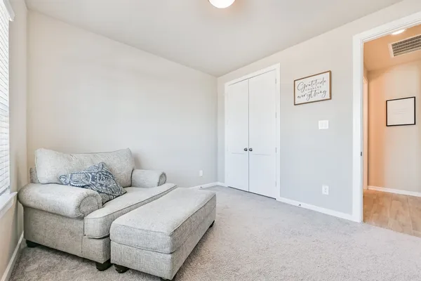 a bedroom with a bed and a television