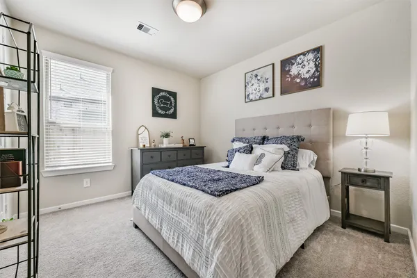 a bedroom with a large bed and a window