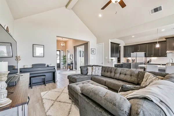 a view of a living room kitchen and a wooden floor