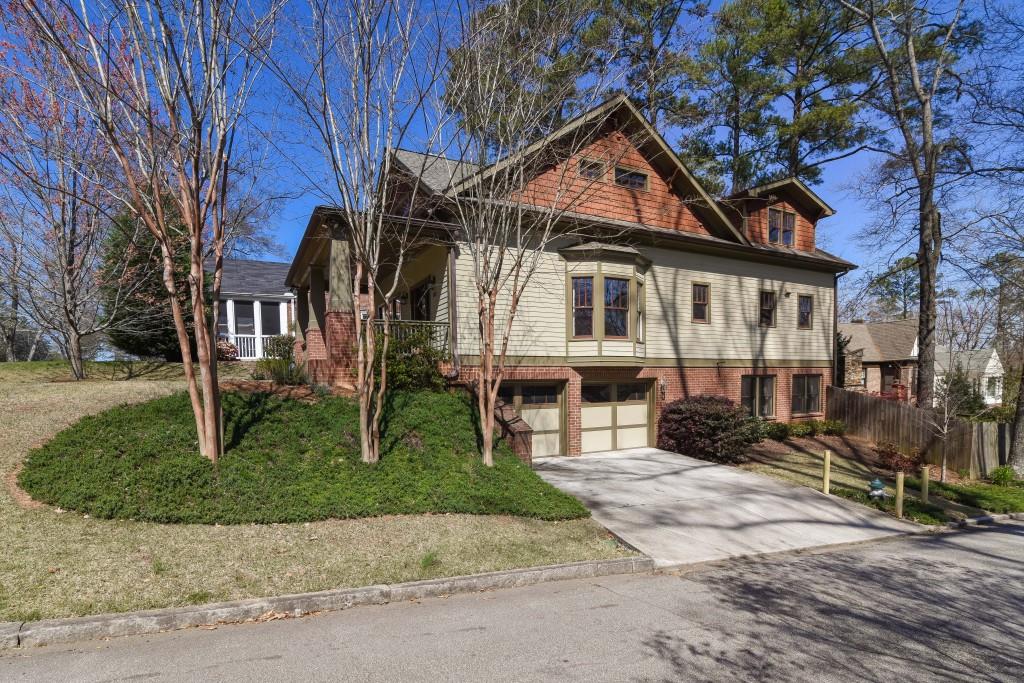 203 Huron Street Decatur, GA 30030 - Photo 1 of 1 a view of a white house with large windows next to a yard