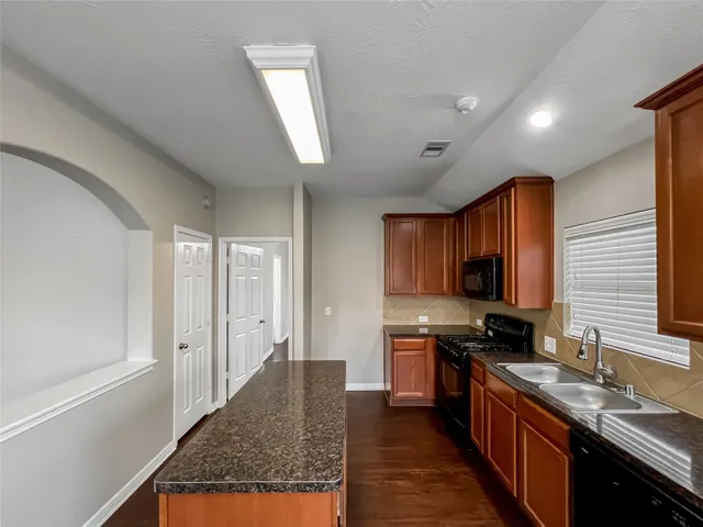 a kitchen with stainless steel appliances granite countertop a stove sink and cabinets