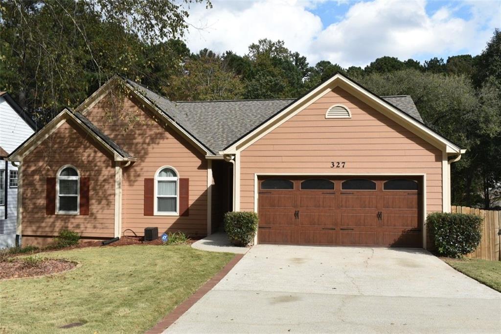 327 Ravinia Way Lawrenceville, GA 30044 - Photo 1 of 1 a front view of a house with a yard and garage
