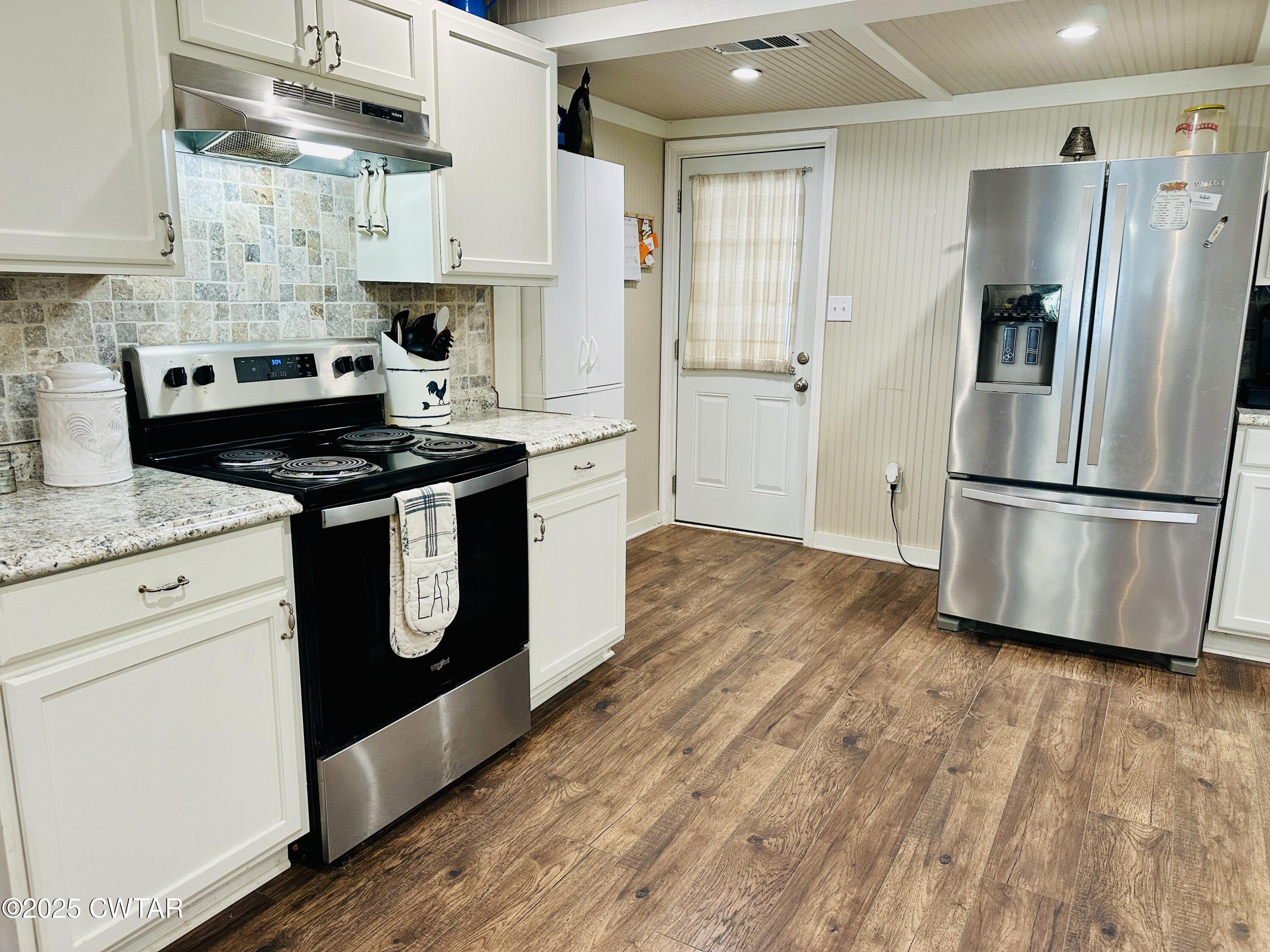 404 McKnight Street Rutherford, TN 38369 - Photo 11 of 33 a kitchen with stainless steel appliances granite countertop a stove a refrigerator and a wooden cabinets