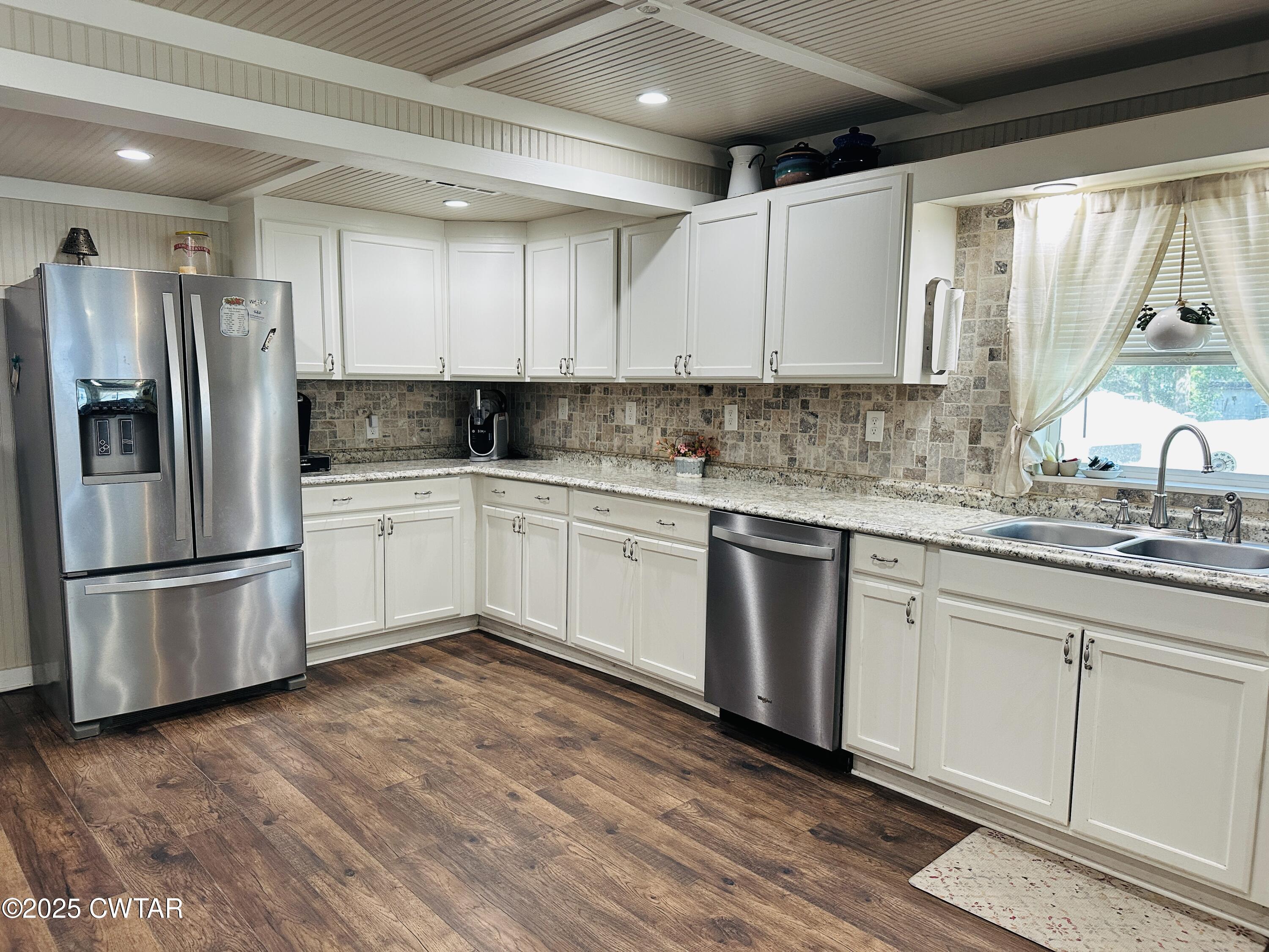 404 McKnight Street Rutherford, TN 38369 - Photo 9 of 33 a kitchen with a sink cabinets stainless steel appliances and a window