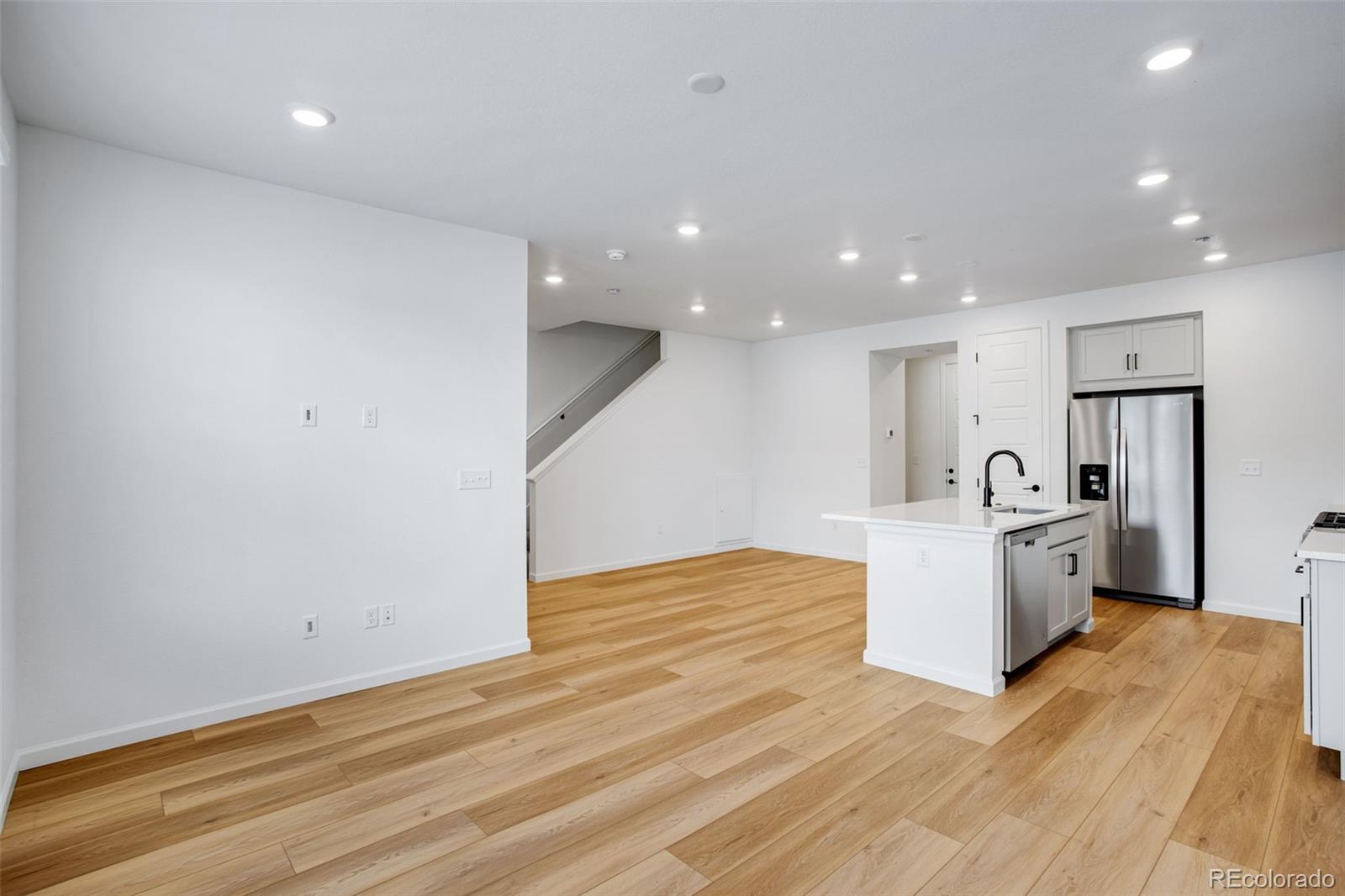 1765 Mount Meeker Avenue Berthoud, CO 80513 - Photo 13 of 37 a view of a kitchen with sink stainless steel appliances furniture and wooden floor