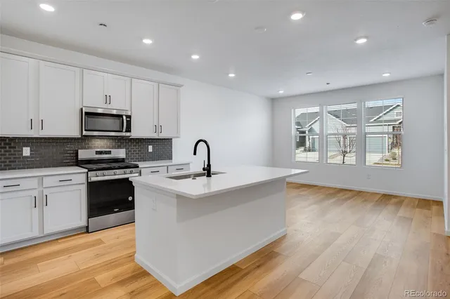 a kitchen with granite countertop a stove and a sink