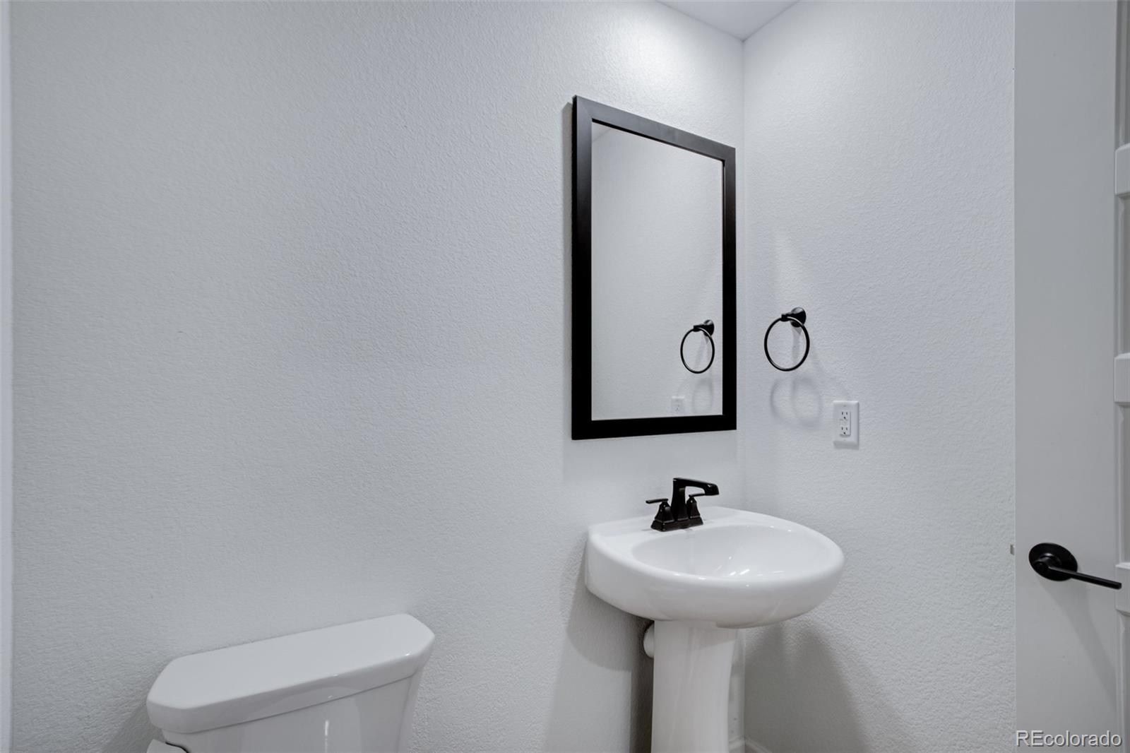 1765 Mount Meeker Avenue Berthoud, CO 80513 - Photo 22 of 37 a bathroom with a toilet sink and mirror